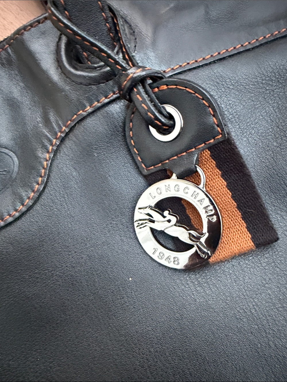 Longchamp black leather tote with logo charm